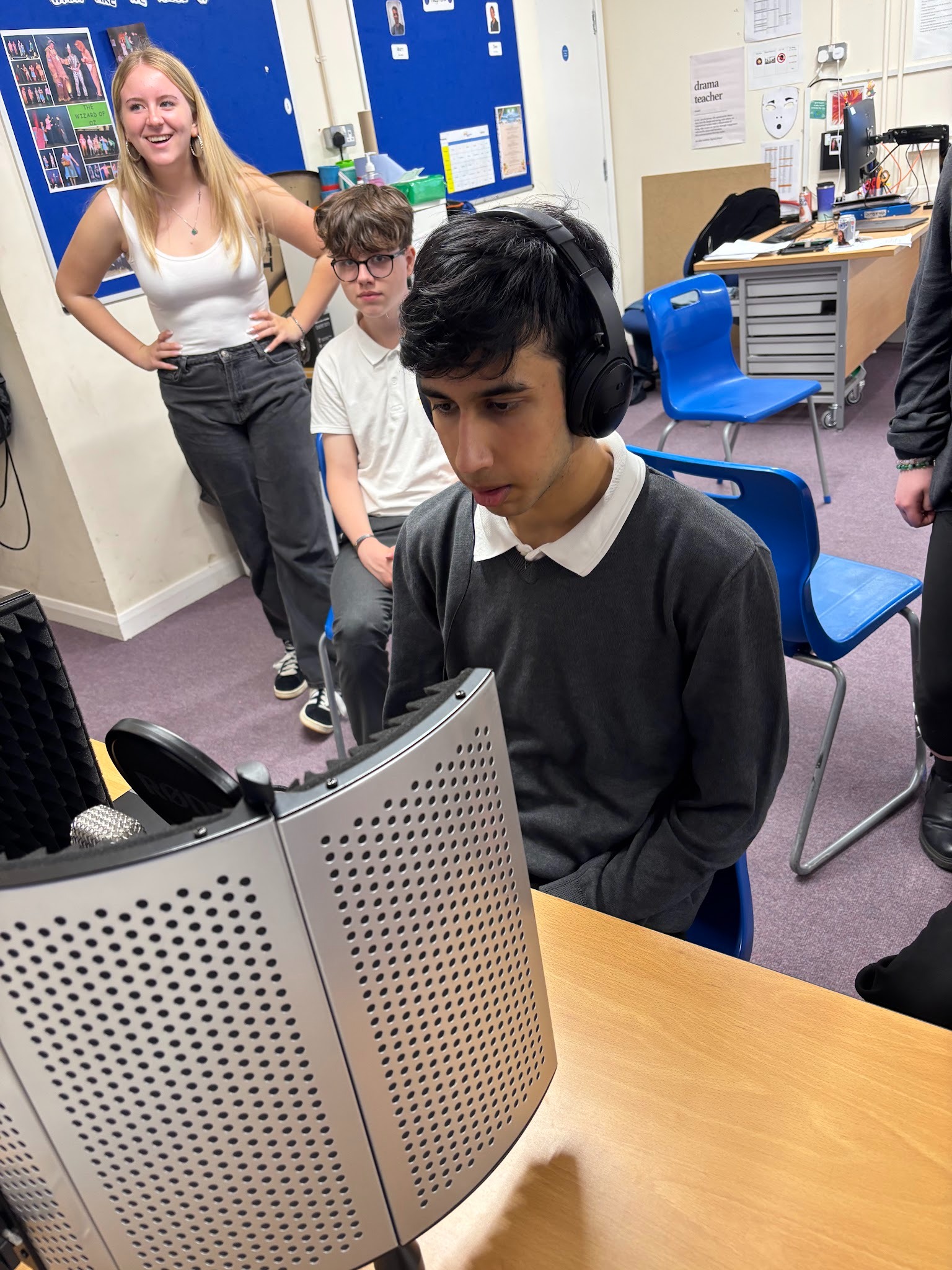 Student in headphones practicing recording an advert
