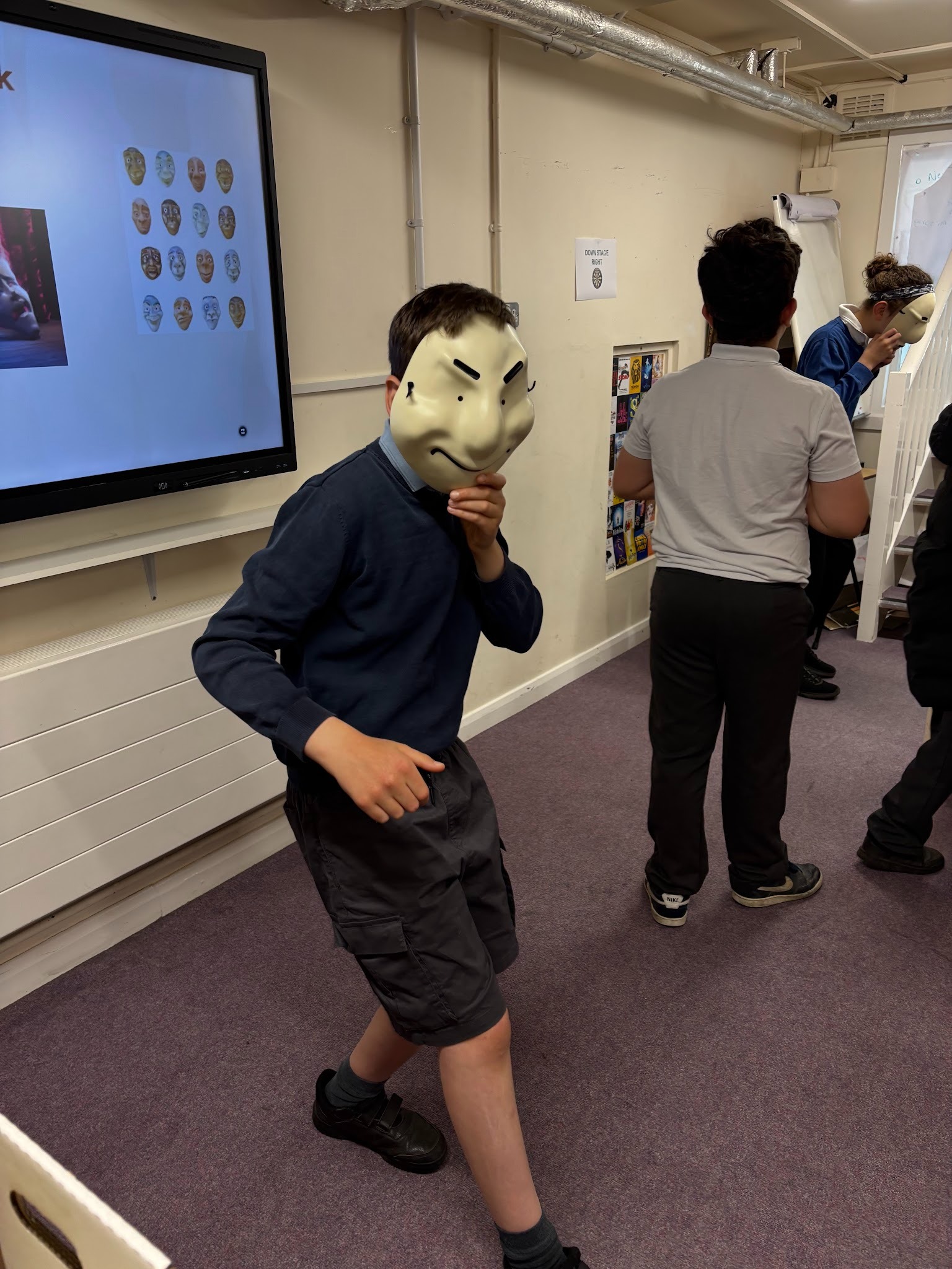 Boy acting wearing a smiling white mask
