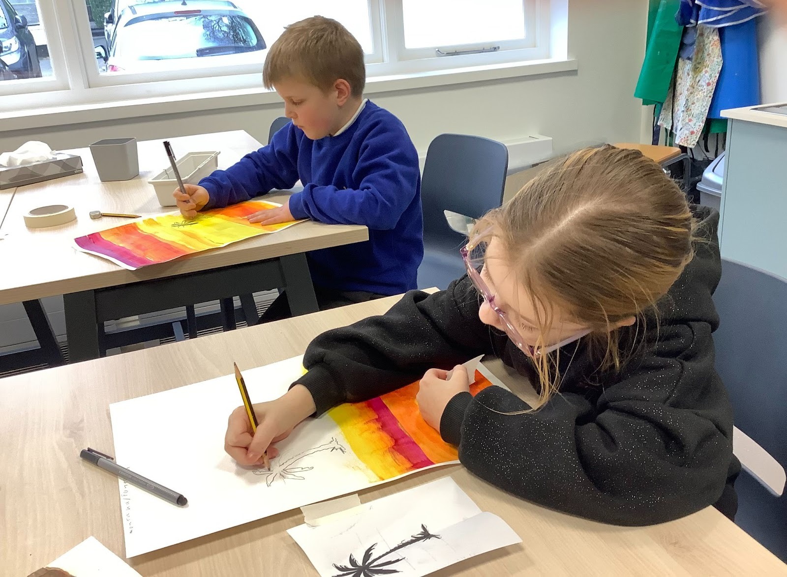 A girl and a boy from Apple class doing their holiday art