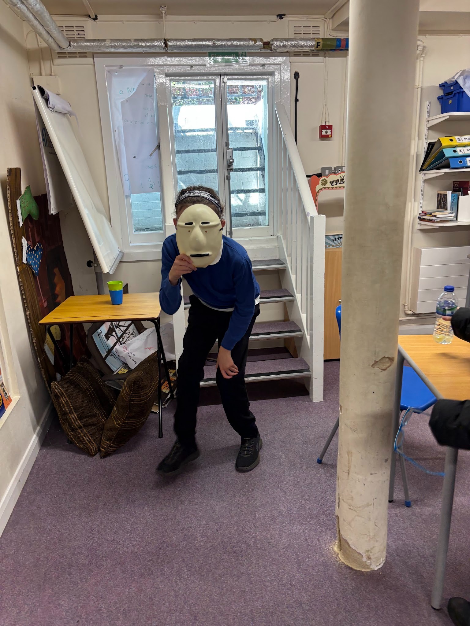 Student acting wearing a white mask