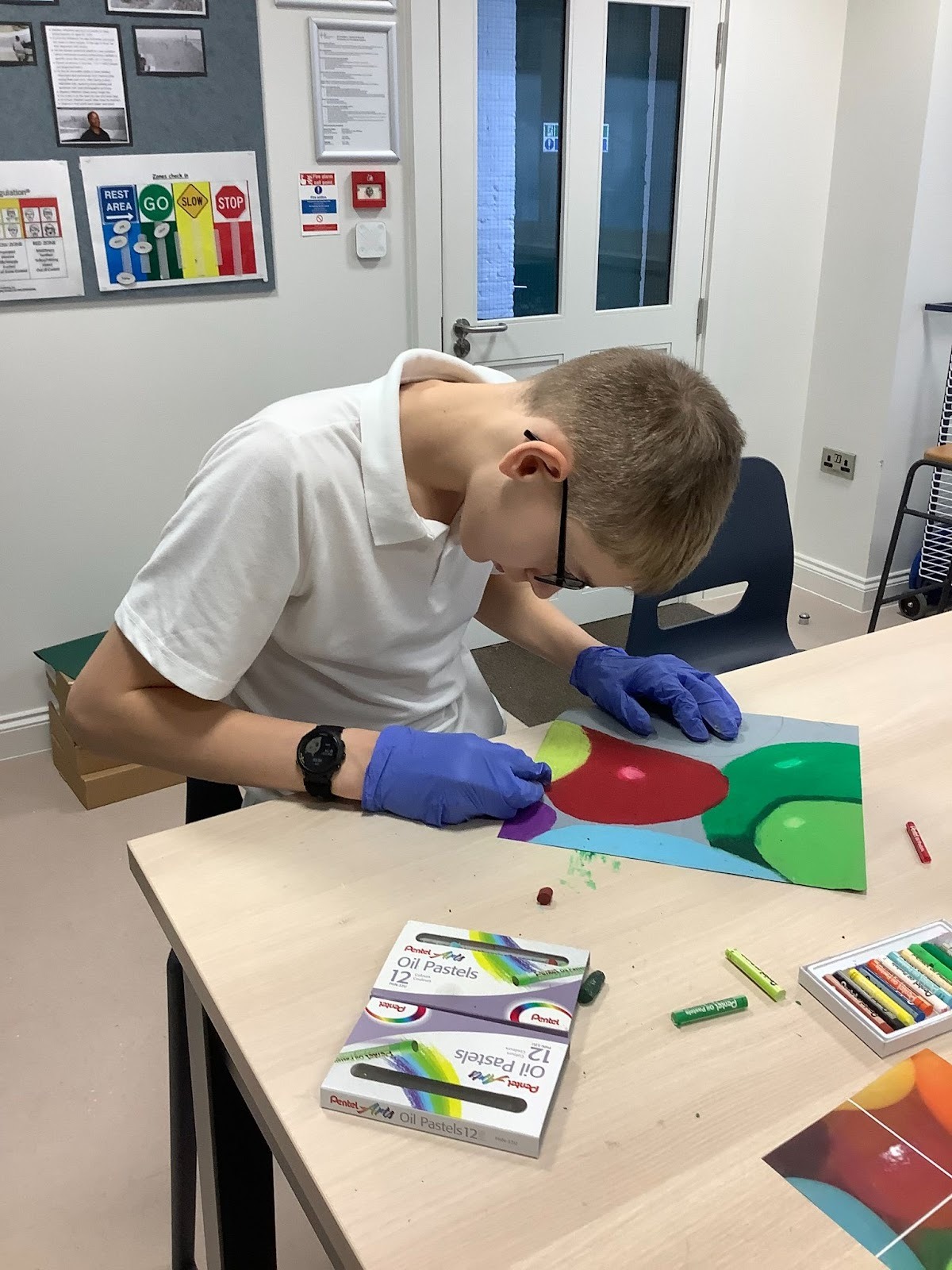 Boy from Mercury class working on his sweet picture