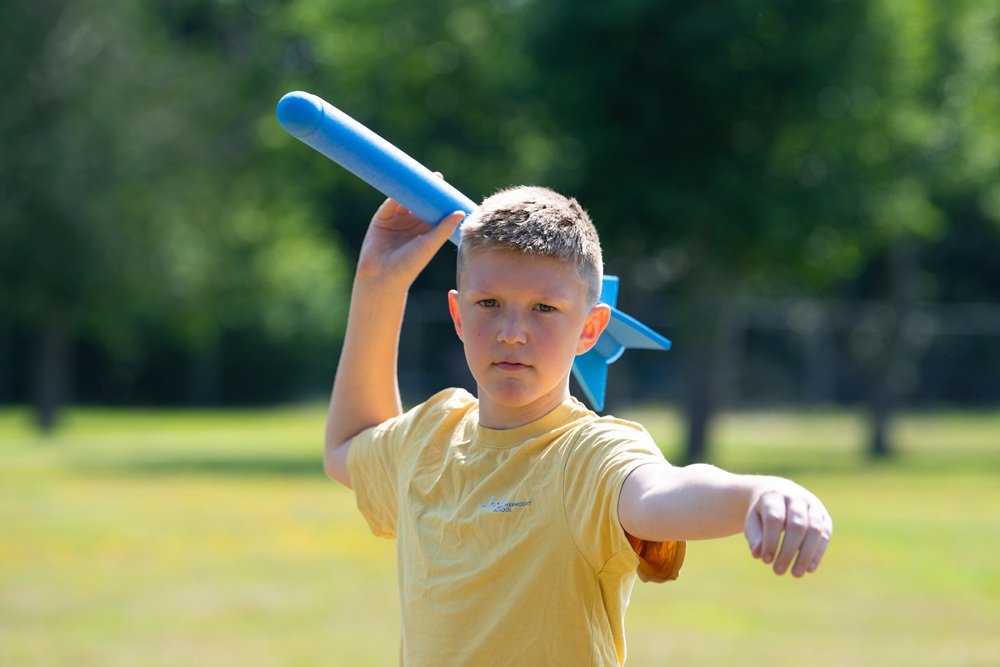 Student throwing foam javelin