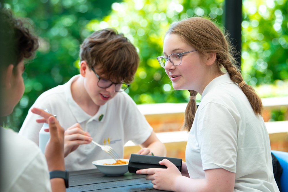 Lunch on the terrace Three students eating lunch on the terrace