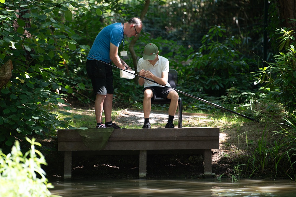 Student and staff member fishing on the lake