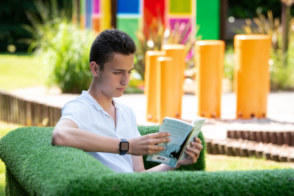 Student reading in the sensory garden