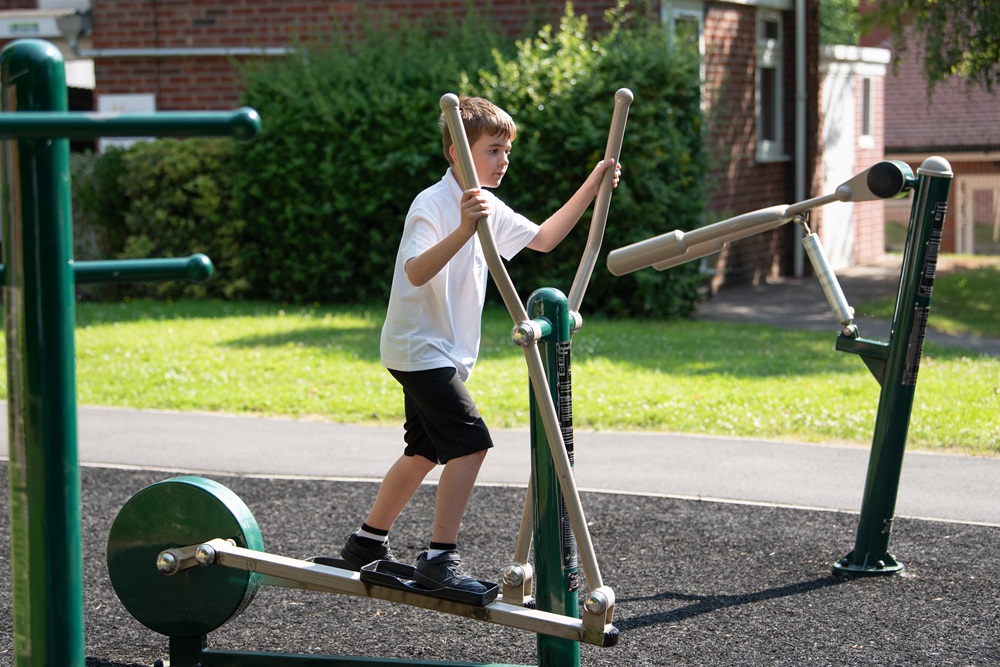 Student on the outdoor gym equipment