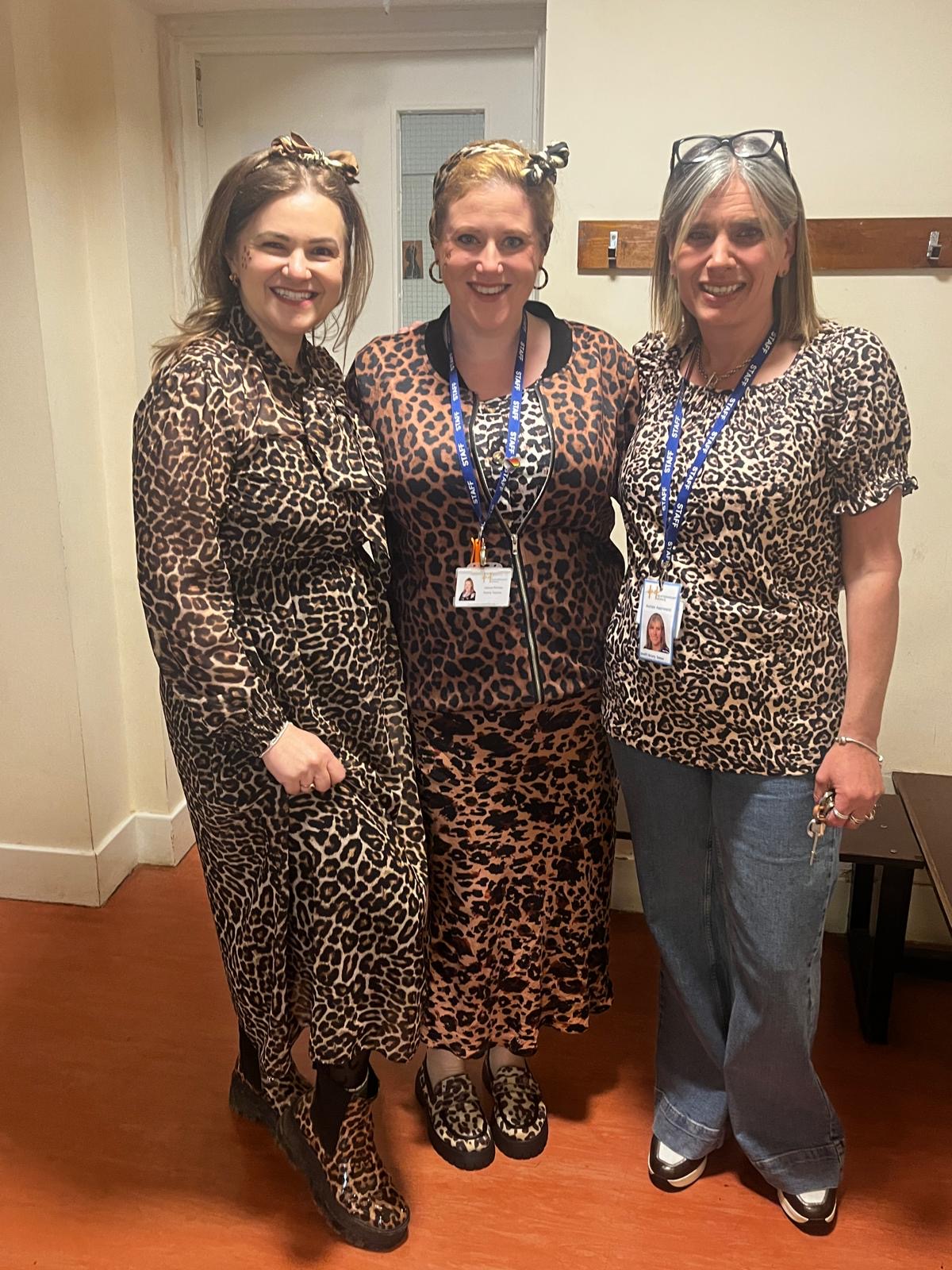 Three members of staff wearing leopard print