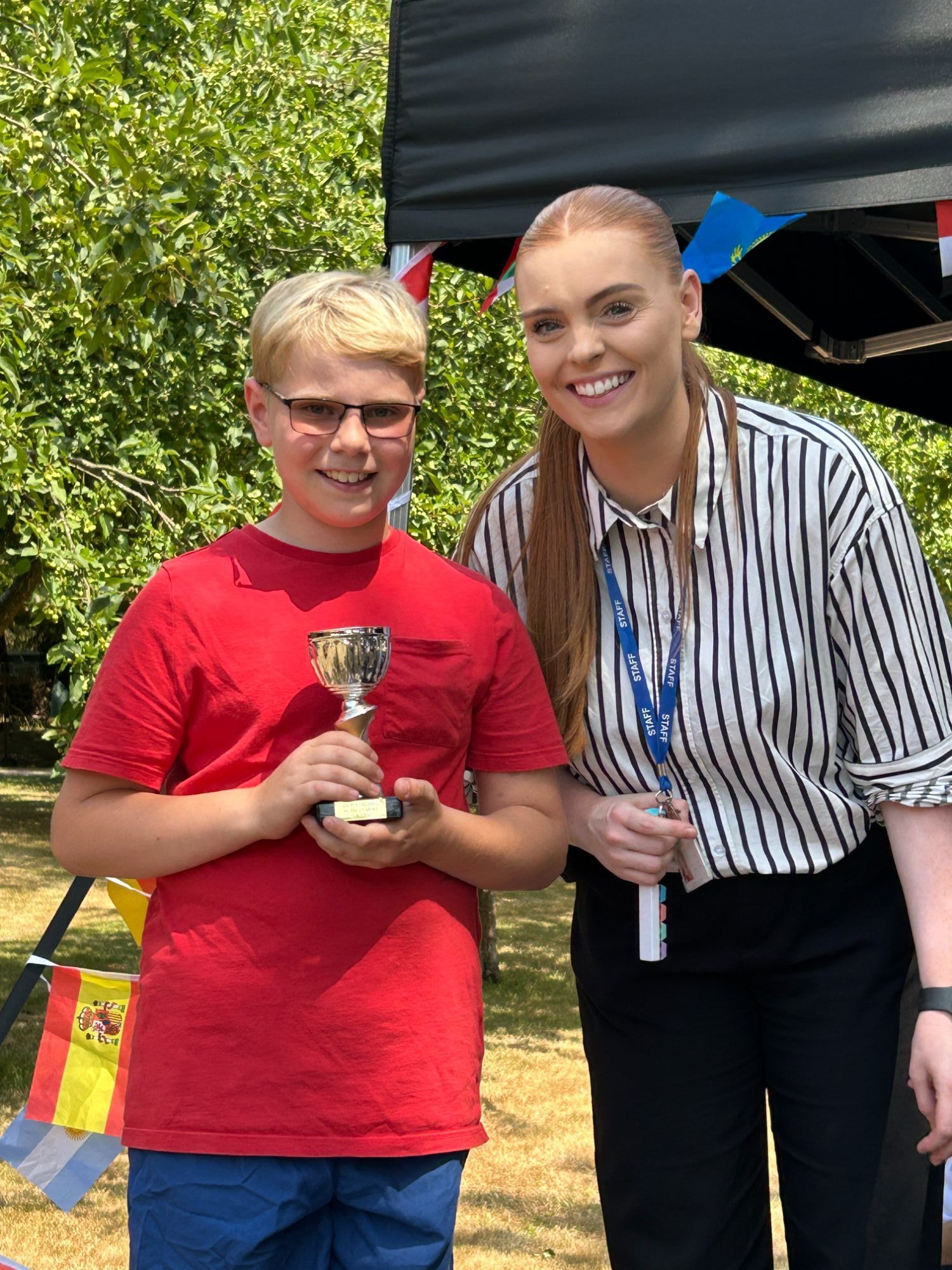 Boy holding his award trophy