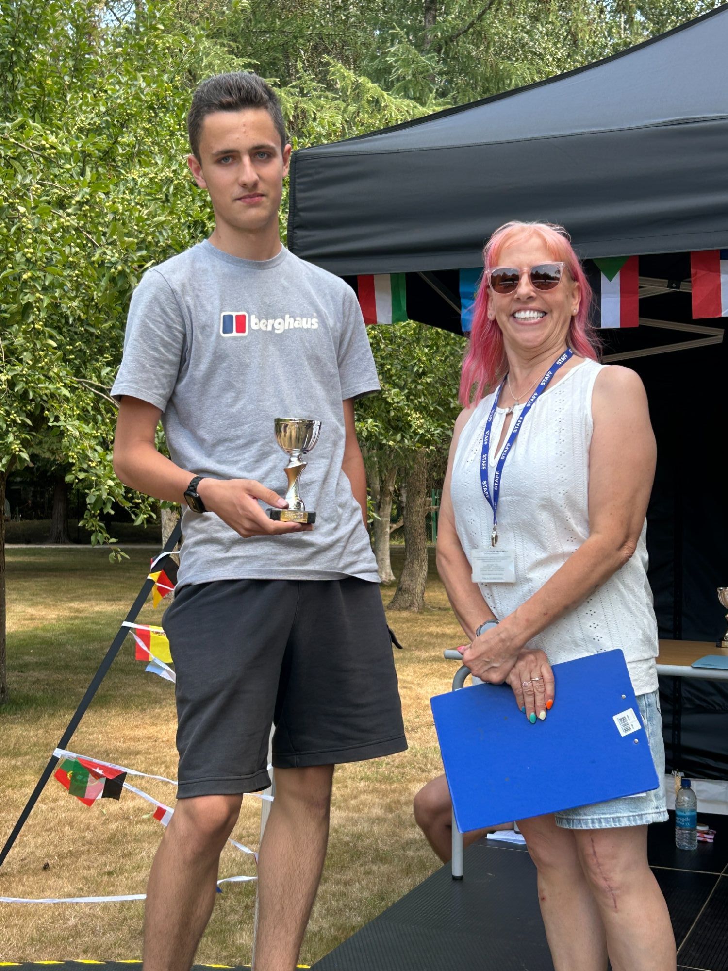 Older boy holding his award trophy