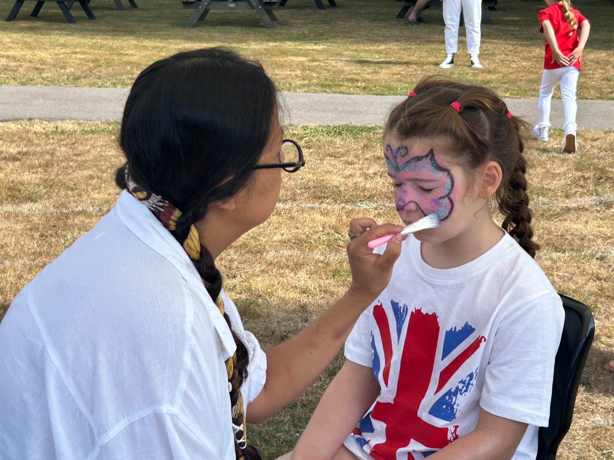 Girl having her face painted