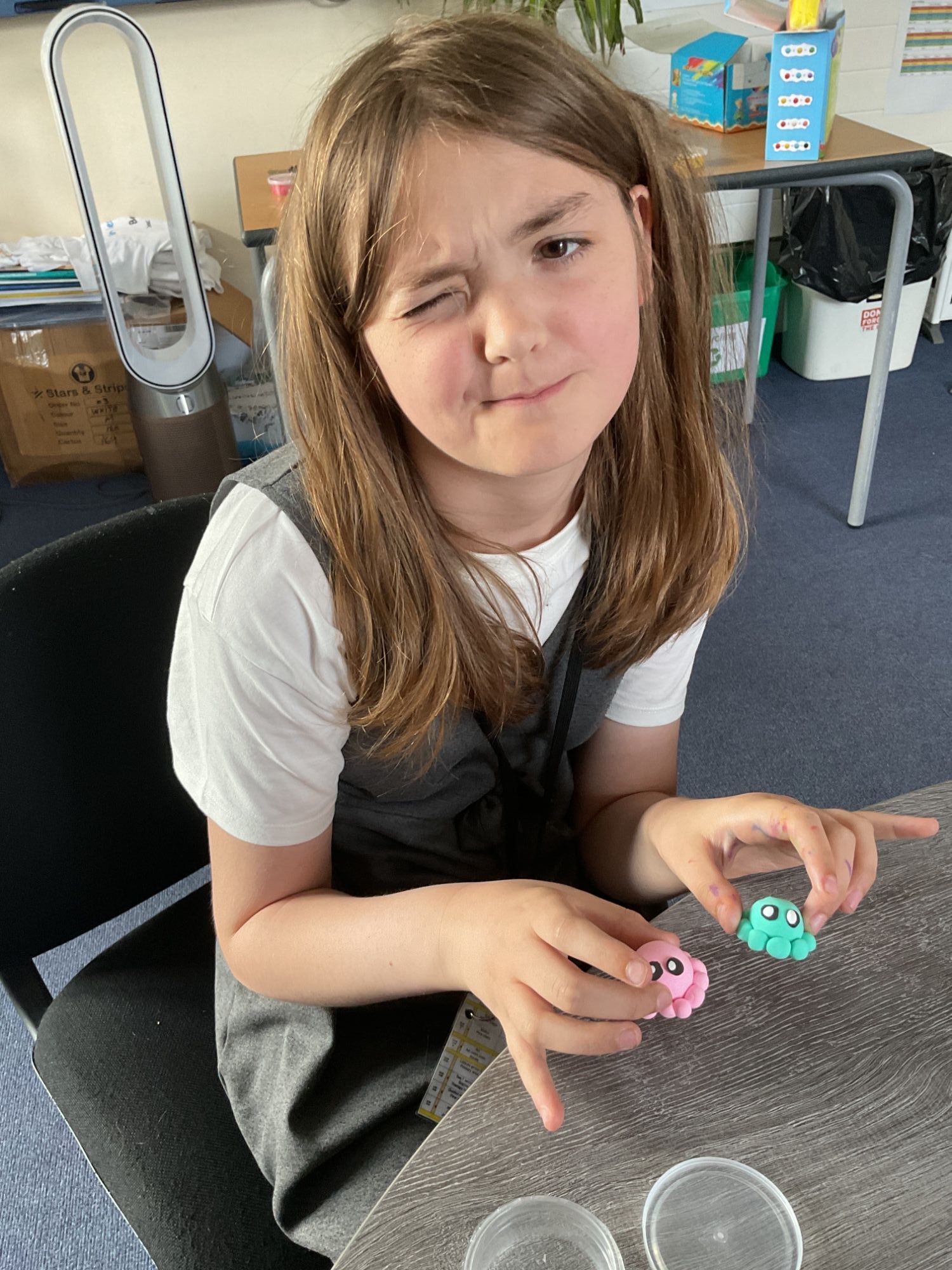 Girl holding her clay  models