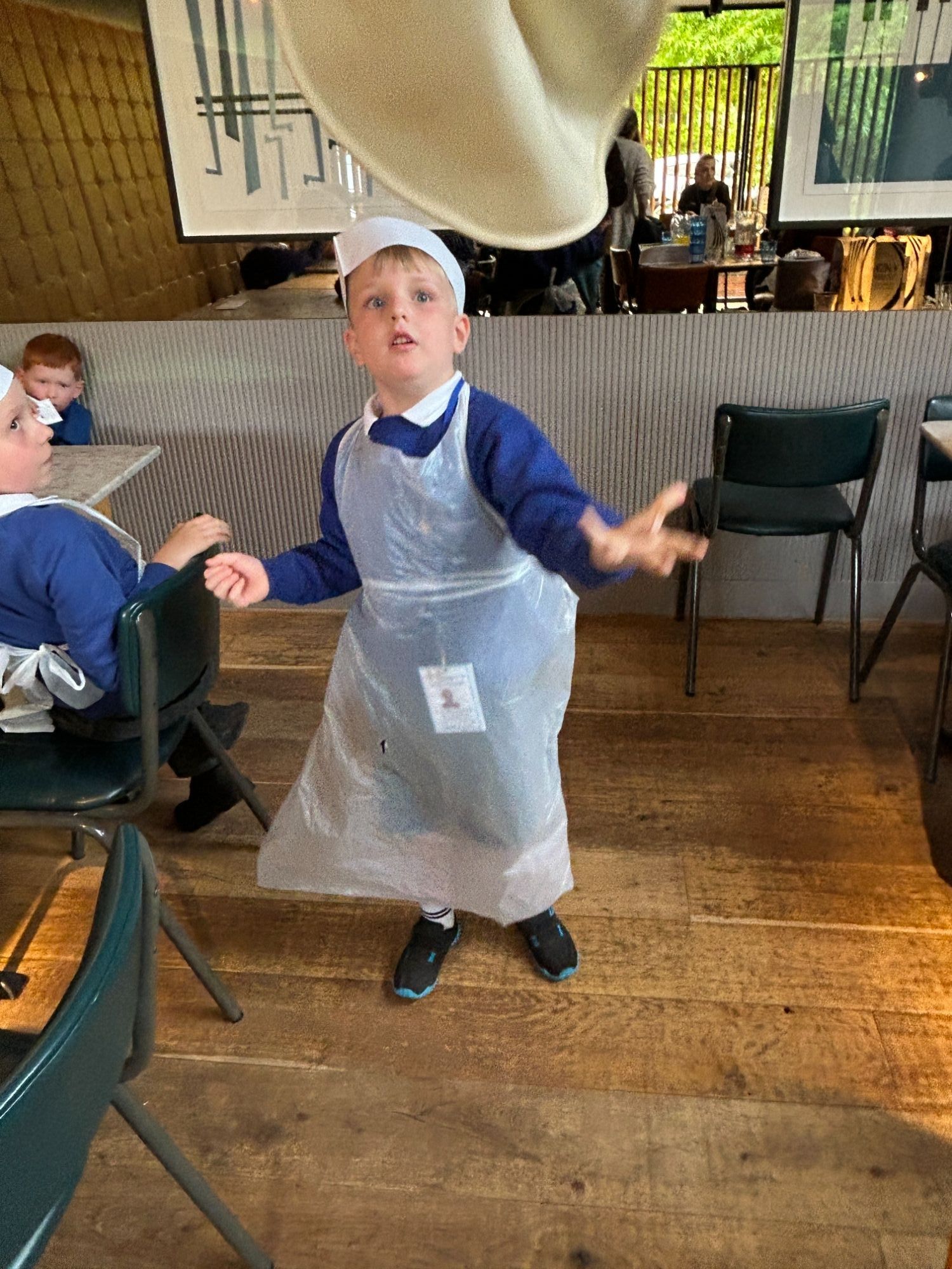 Boy tossing a pizza