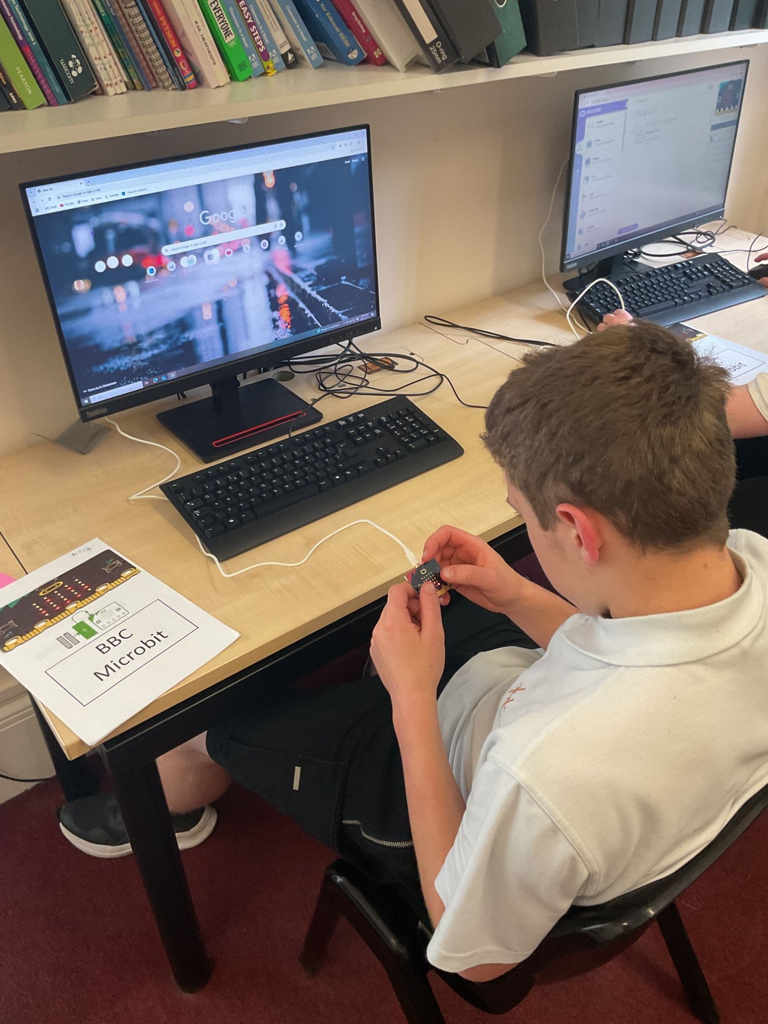 Student at a computer using a microbit