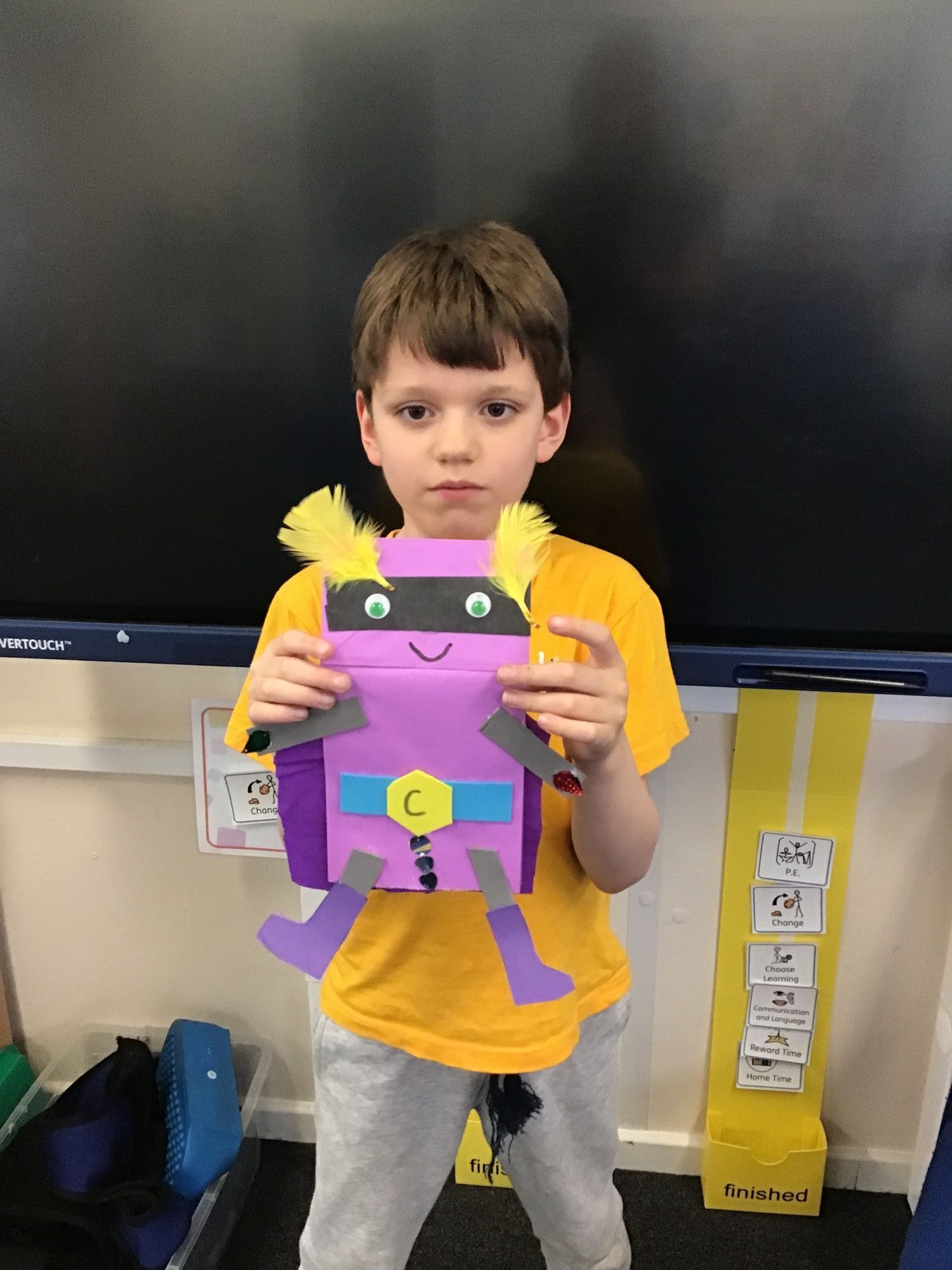Student holdin his superhero art