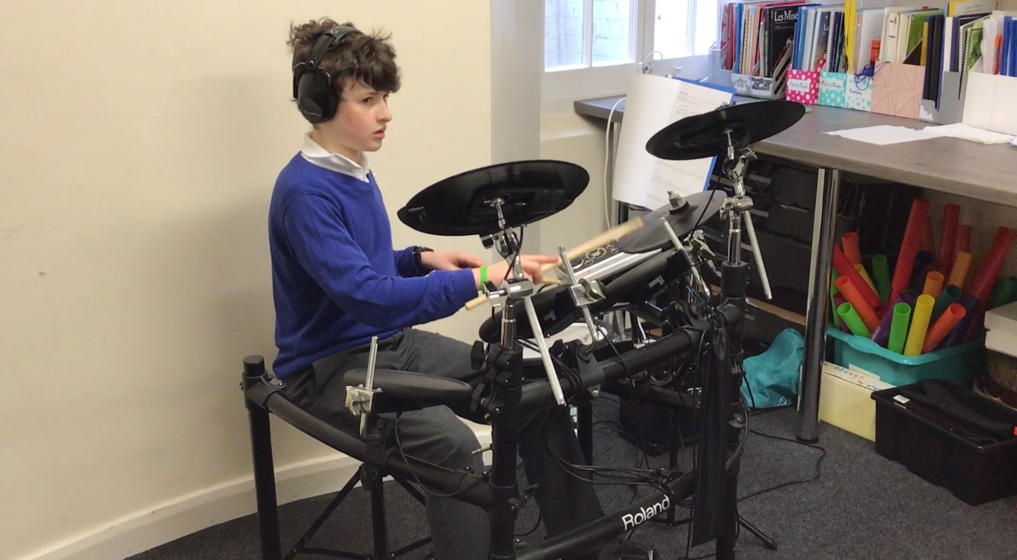 A member of Beech Class on the drums
