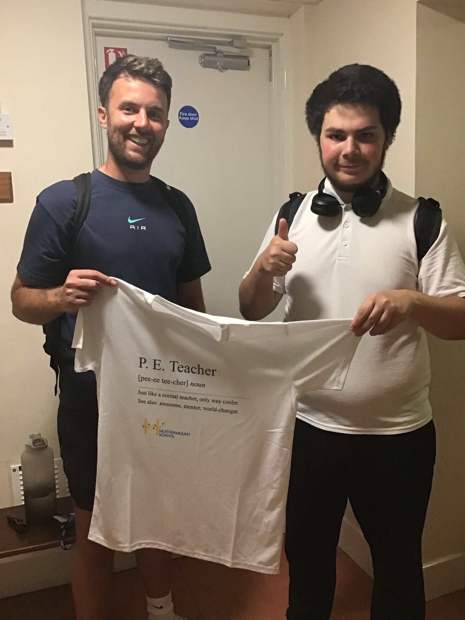 Charlie giving his T-shirt to the PE teacher