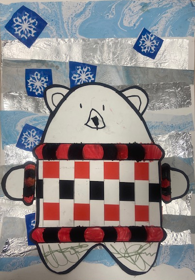 Picture of a polar bear with a red woven jumper