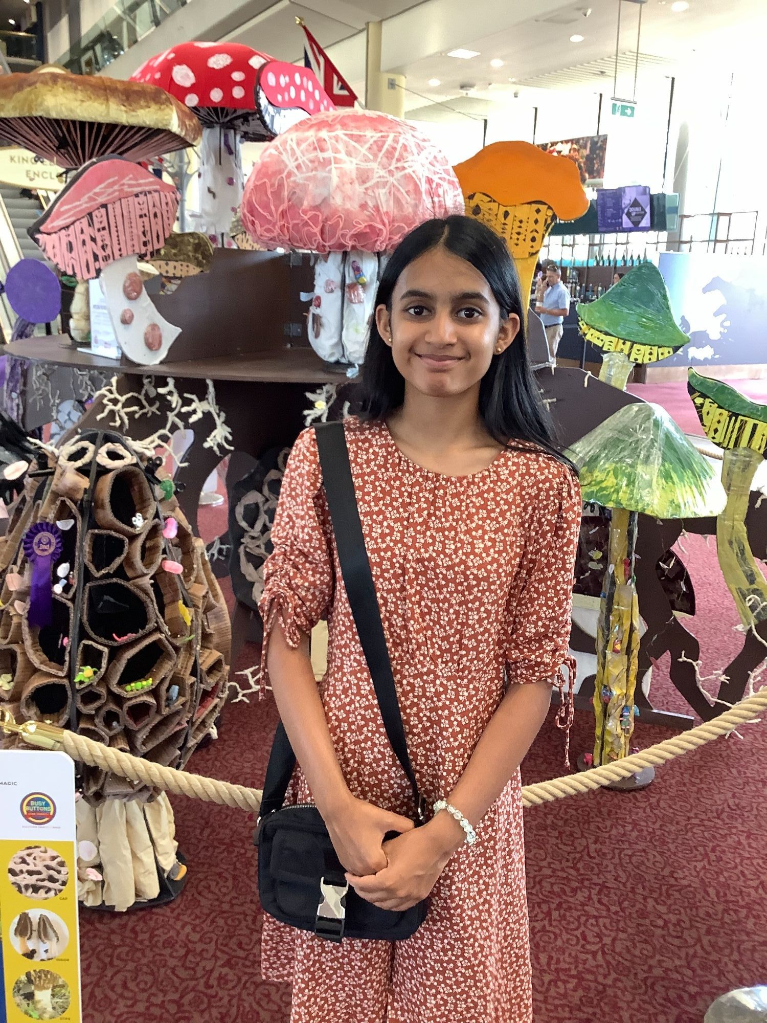 Student smiling infront og the art display