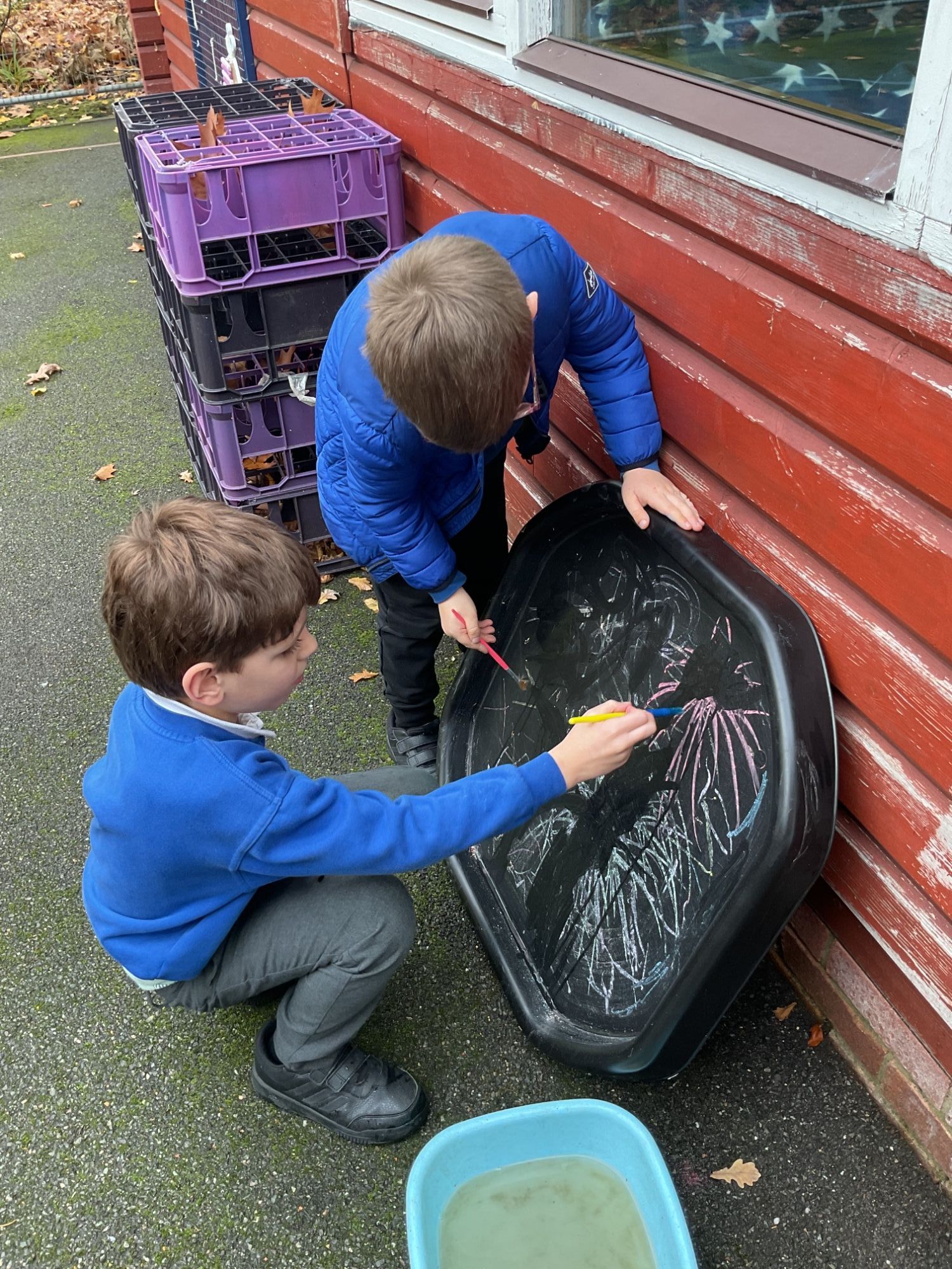 Two students drawing fireworks Two students drawing fireworks with coloured chalk