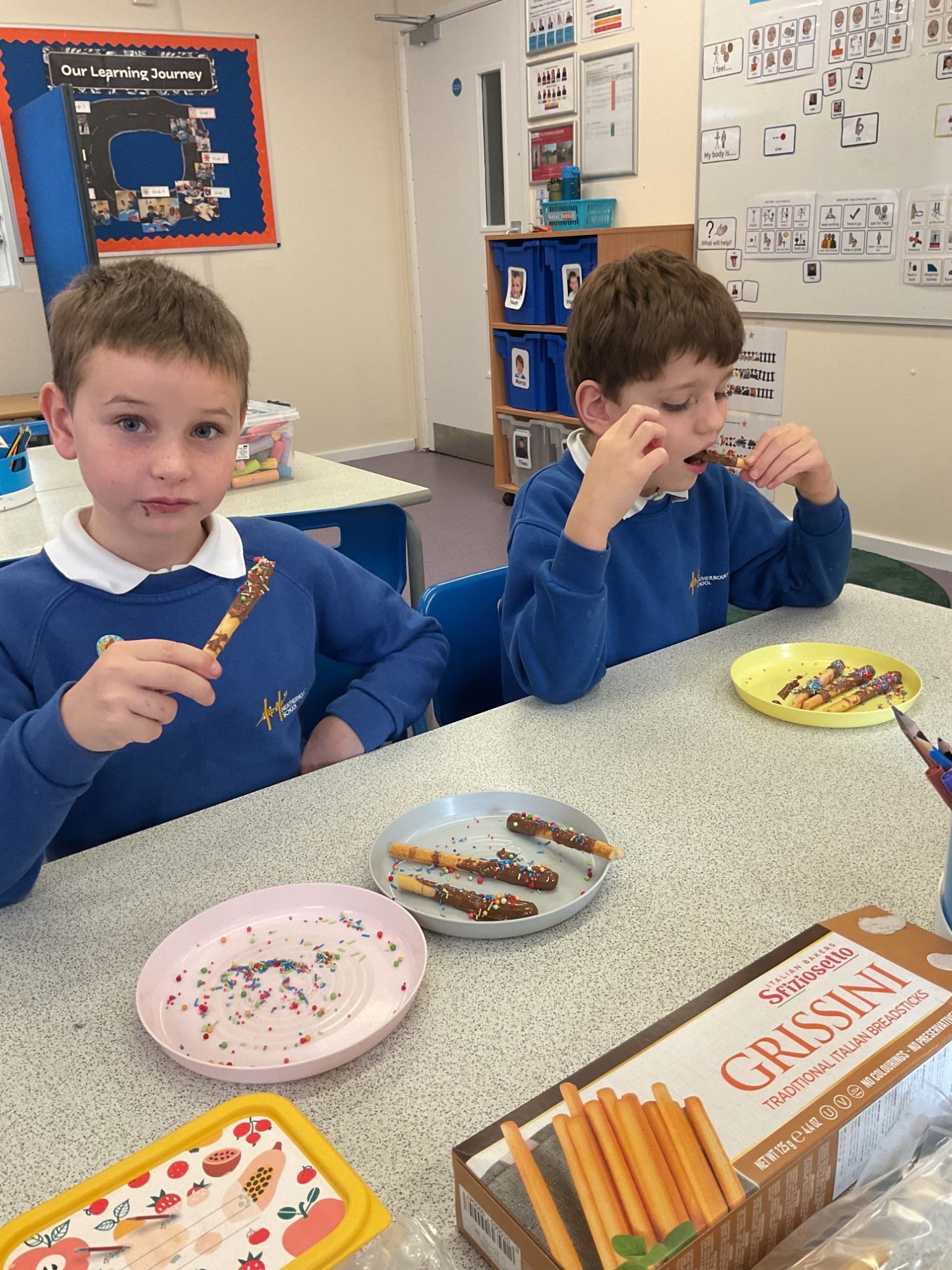 Boys enjoying their breadstick sparklers Two boys enjoying the breadstick sparklers they have made