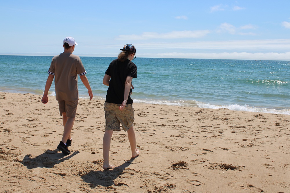 Two students walking on the beach