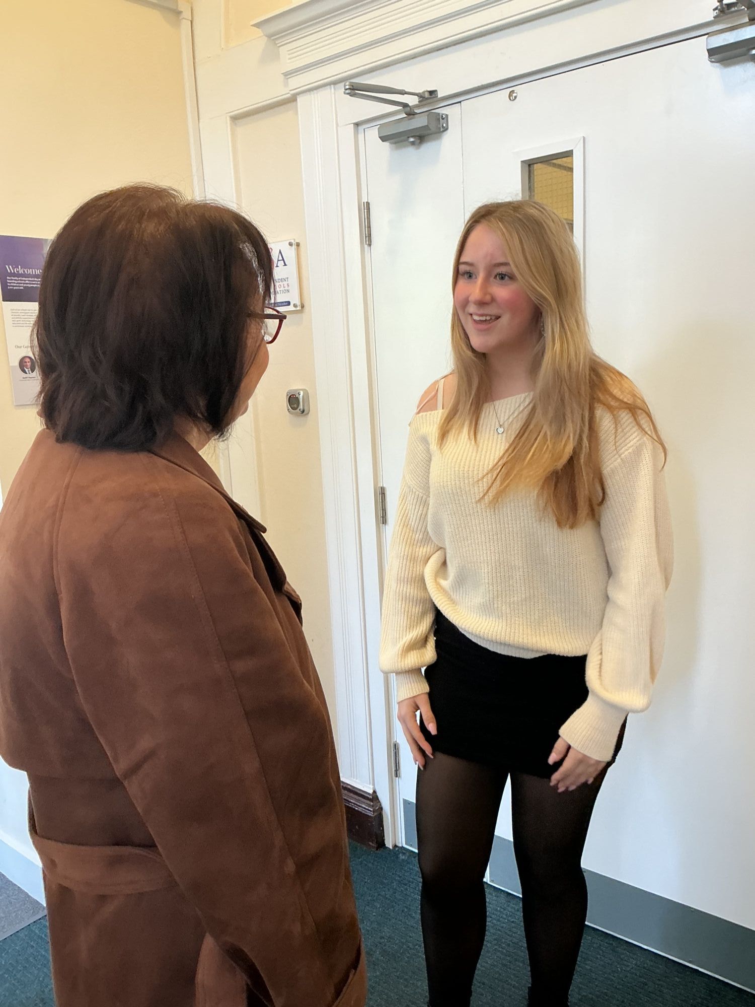 Student greeting a business person