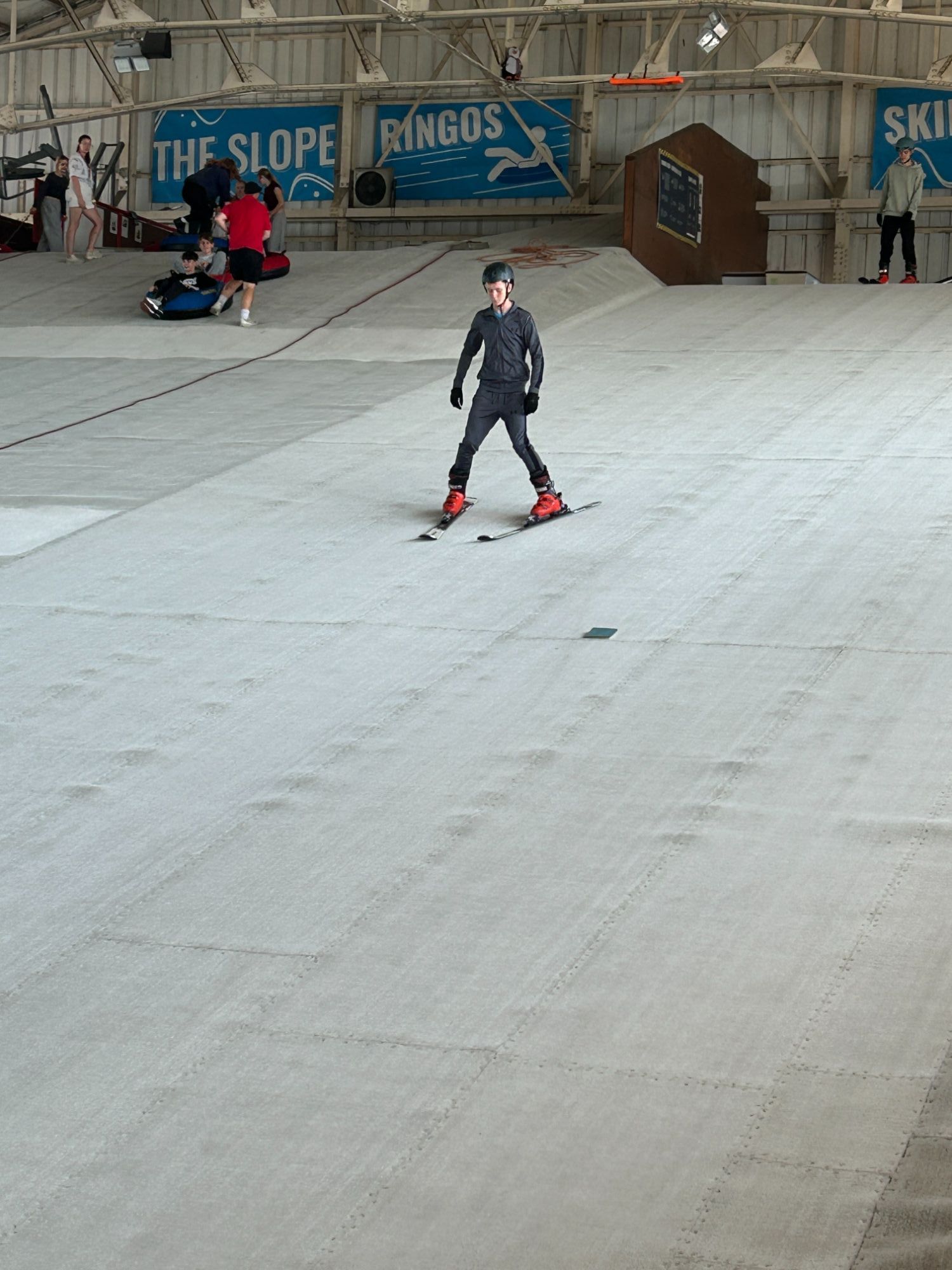 Student skiing down the dry ski slope