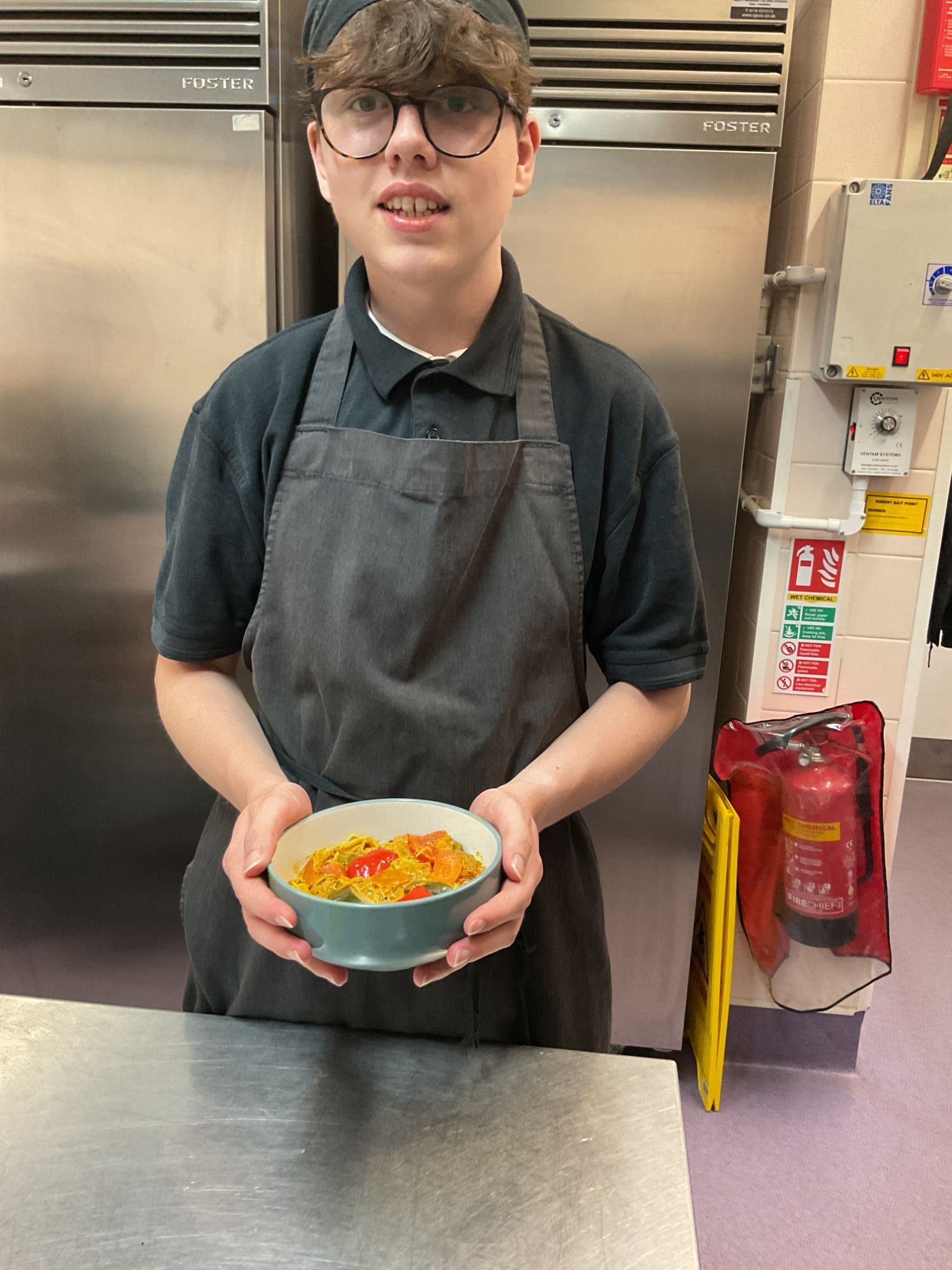 Student holding his finished curry