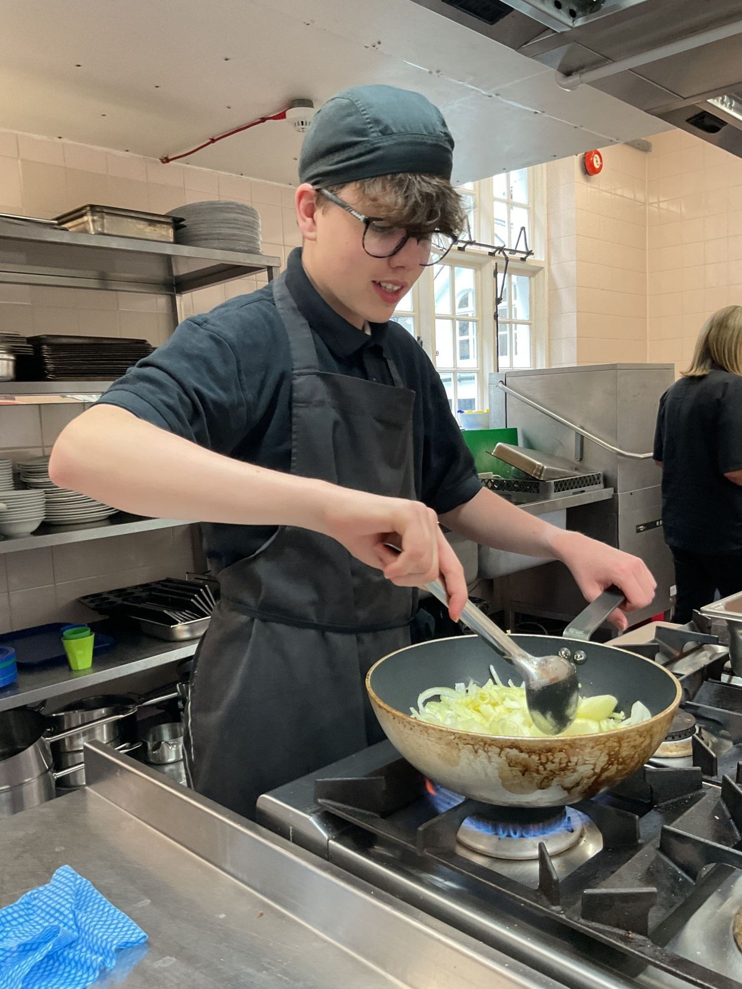 Boy stirring his curry in the wok