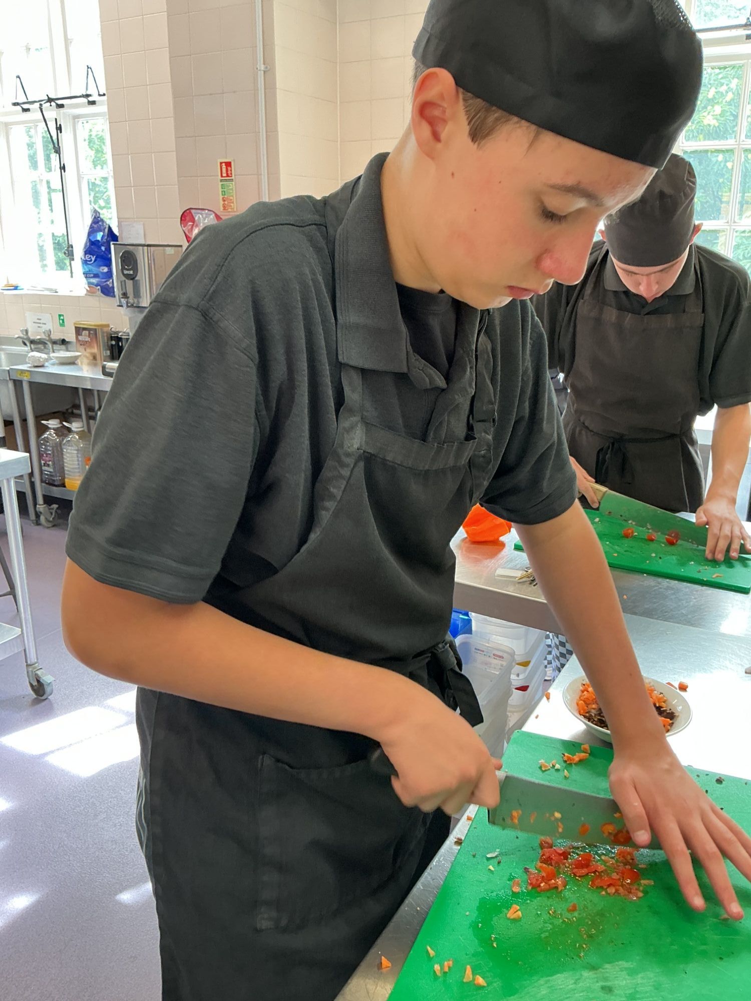 Student cutting a vegetable