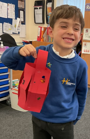 Finished lantern Happy boy holding the red lantern he has made