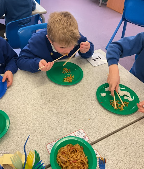 Children eating with chopsticks