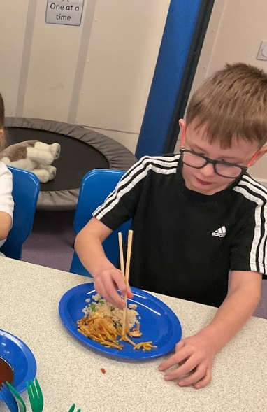 Boy using chopsticks Boy using chopsticks