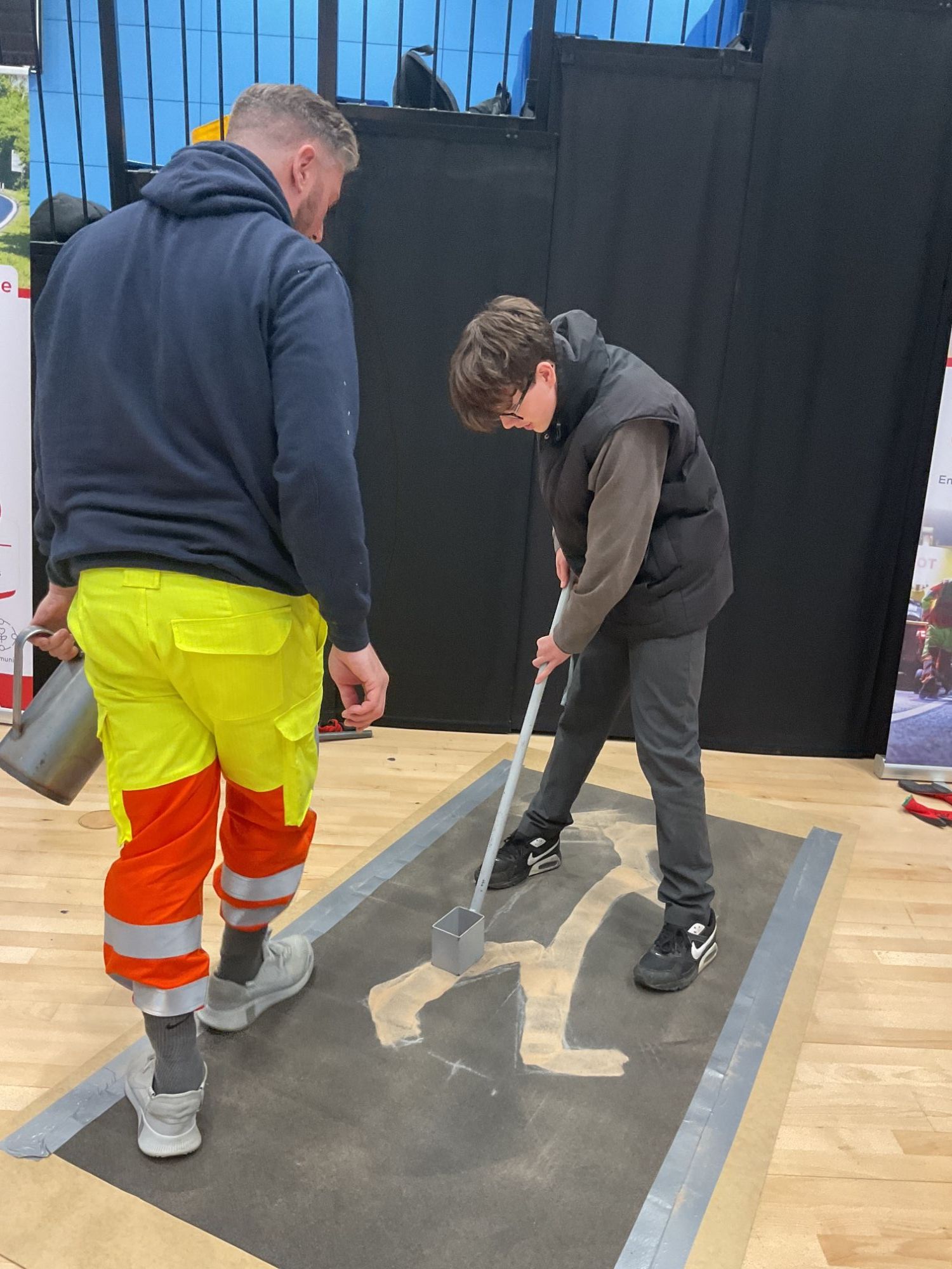 Student marking a road sign with paint