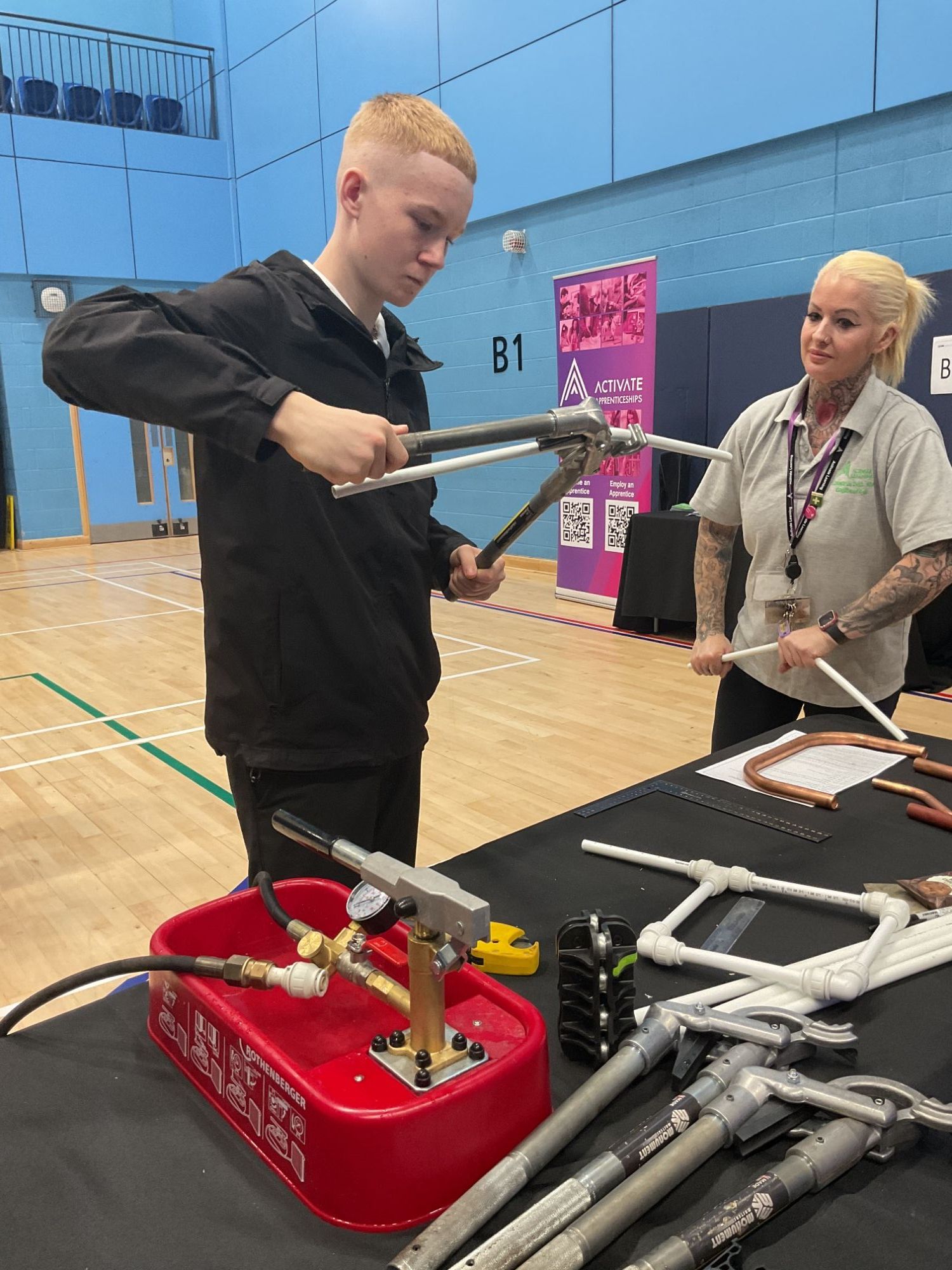 Student at constructionfest holding a tool