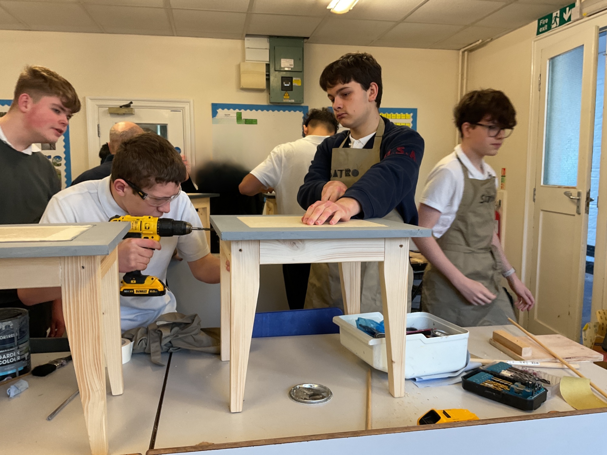 Side tables Busy classroom with students all working on their side tables