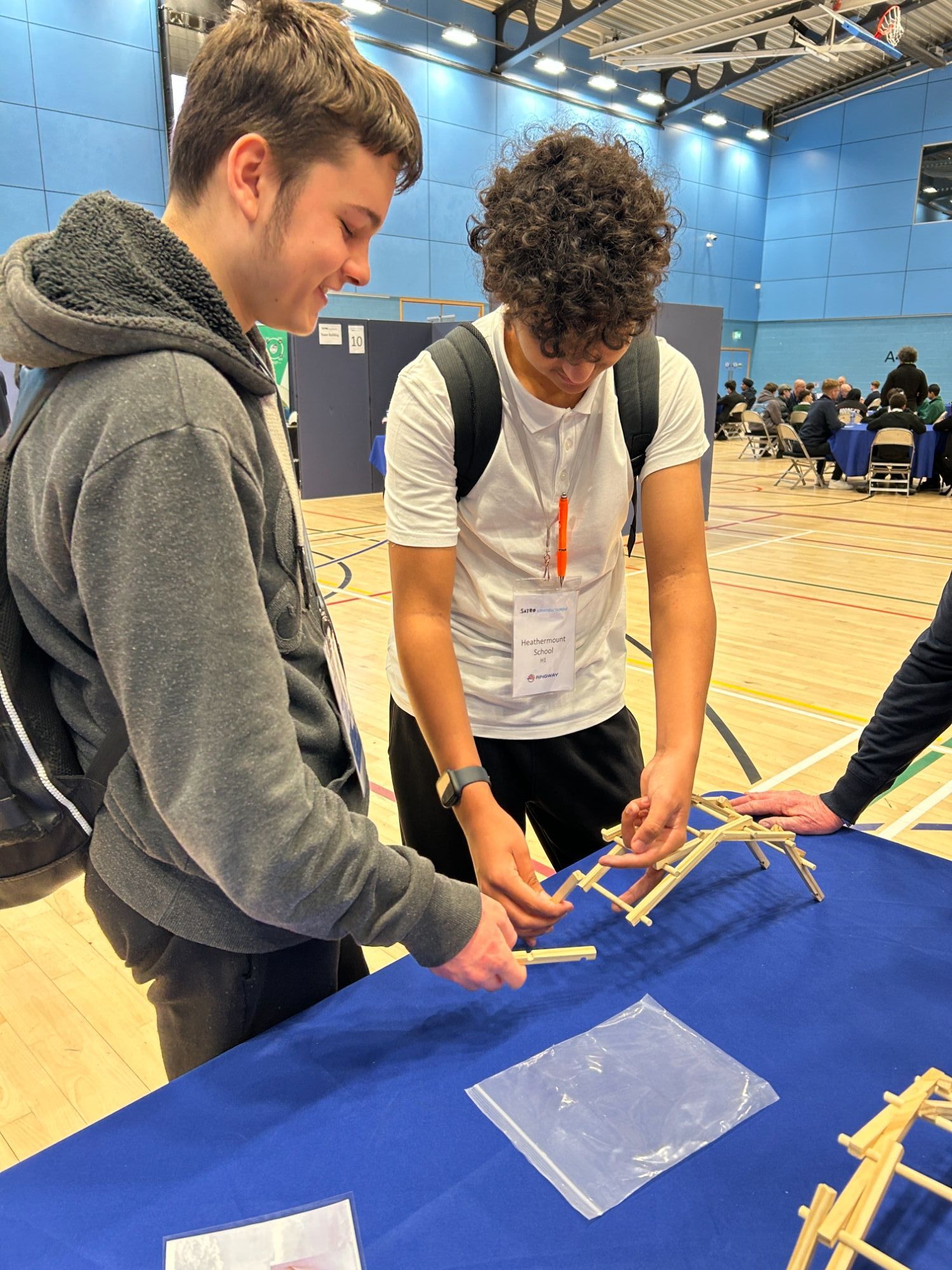 Two students building a model of a bridge at ConstructionFest