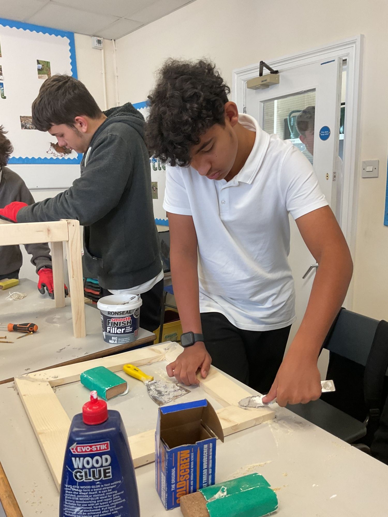 Students applting woodfiller
