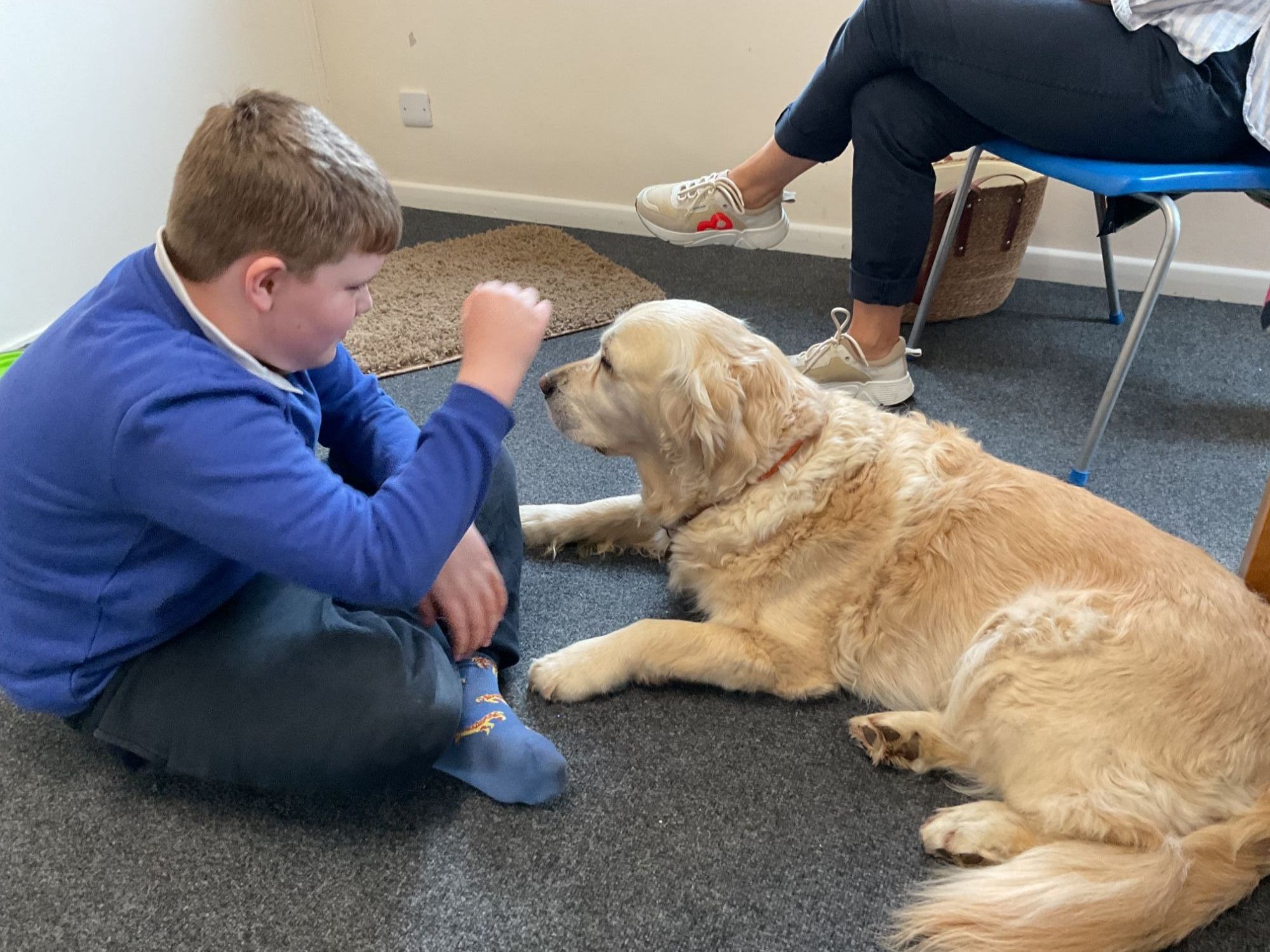 Boy sitting in the floor with Custard