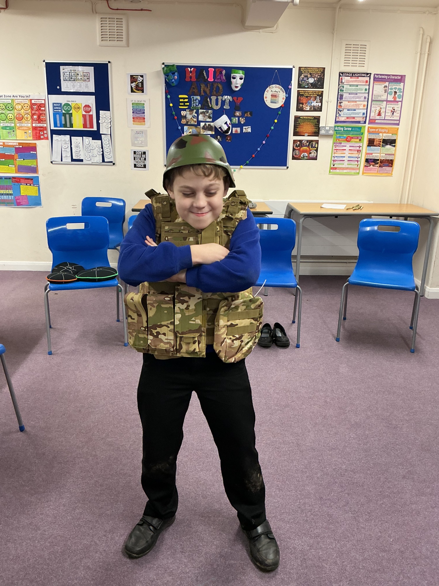 Boy from Elm wearingan army hat and jacket.
