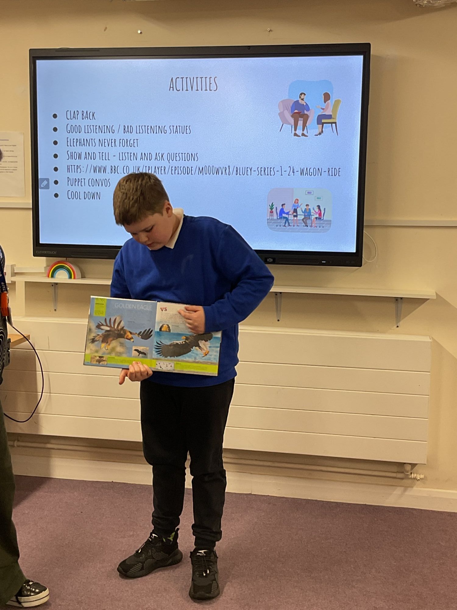 Boy from Oak presenting with a book in hand
