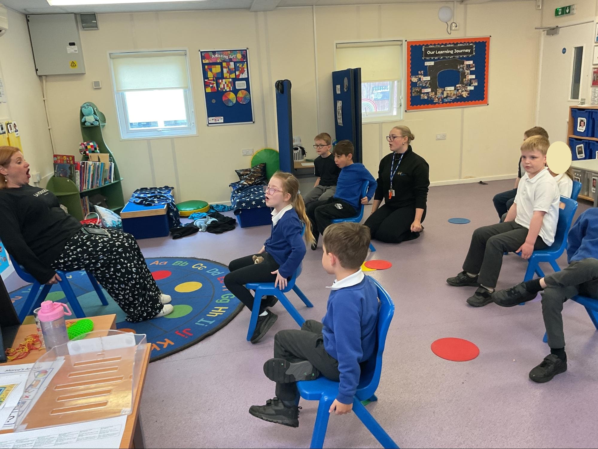 Foundation class sat on chairs practicing their acting