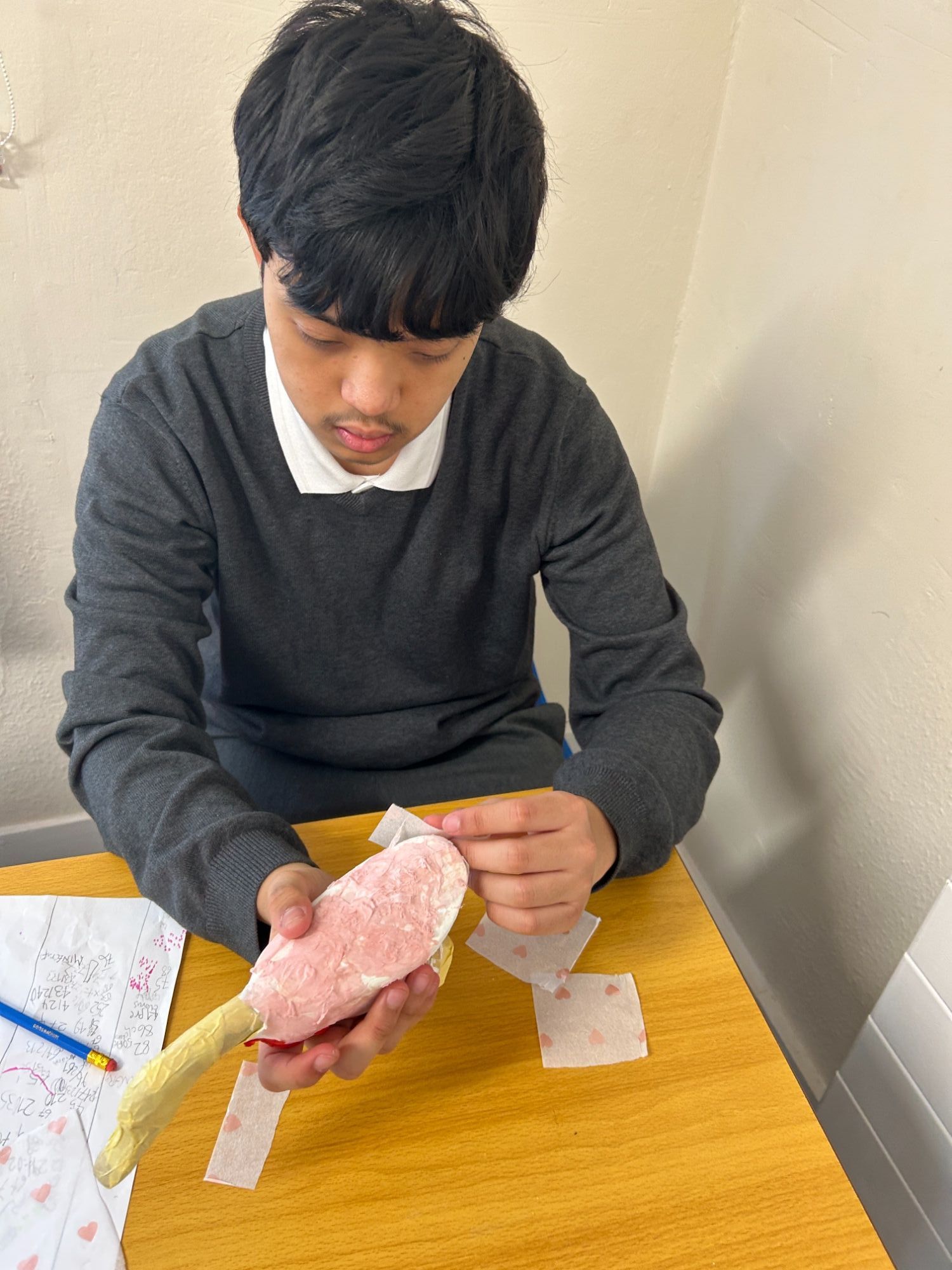 Boy addind tissue paper to his duck