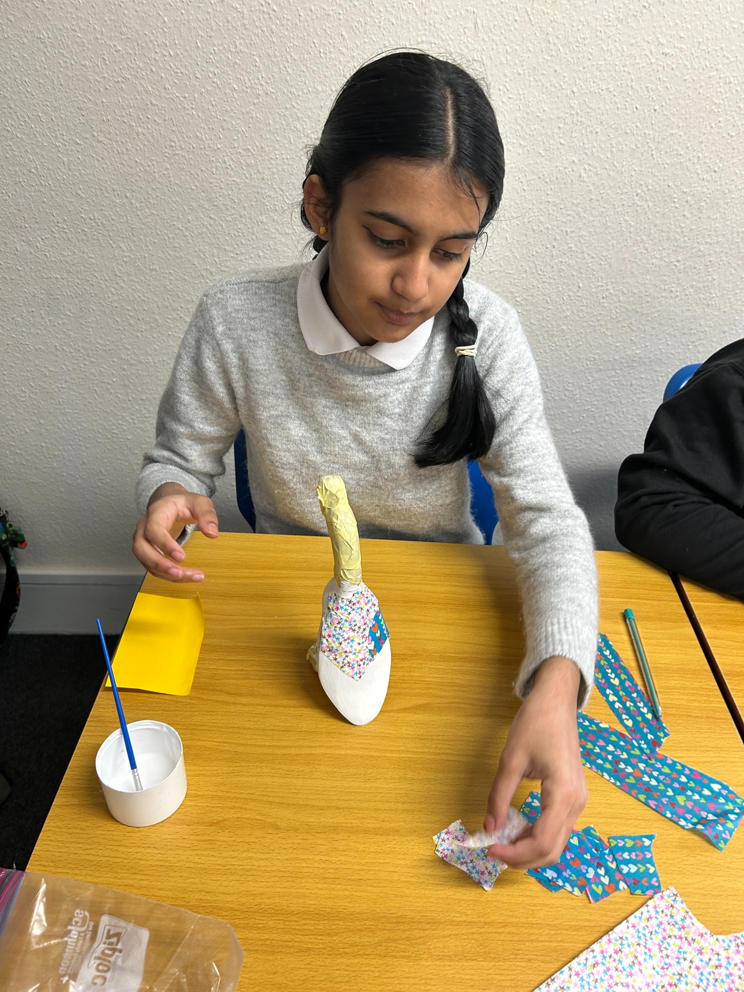 Girl carefully adding tissue to her duck