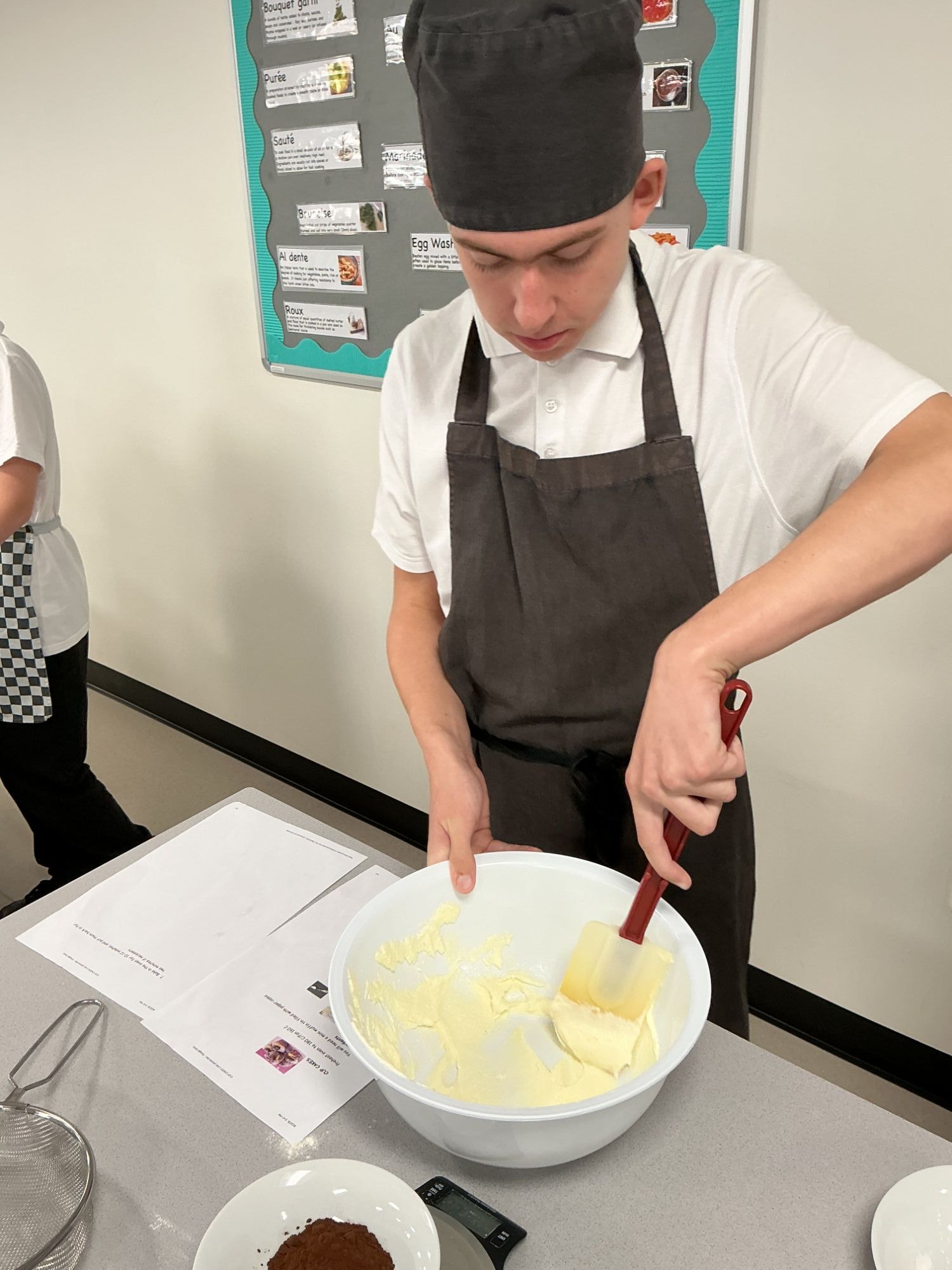 Student mixing butter in a bowl