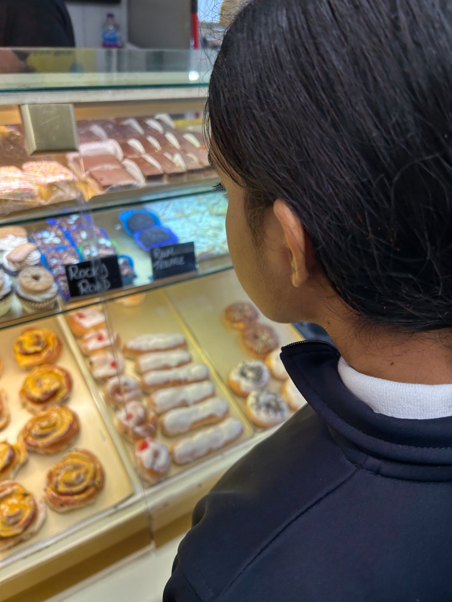 Student choosing her cake from a display