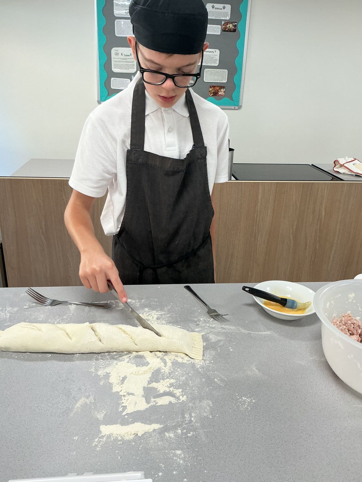Student chopping his mummy sausage roll
