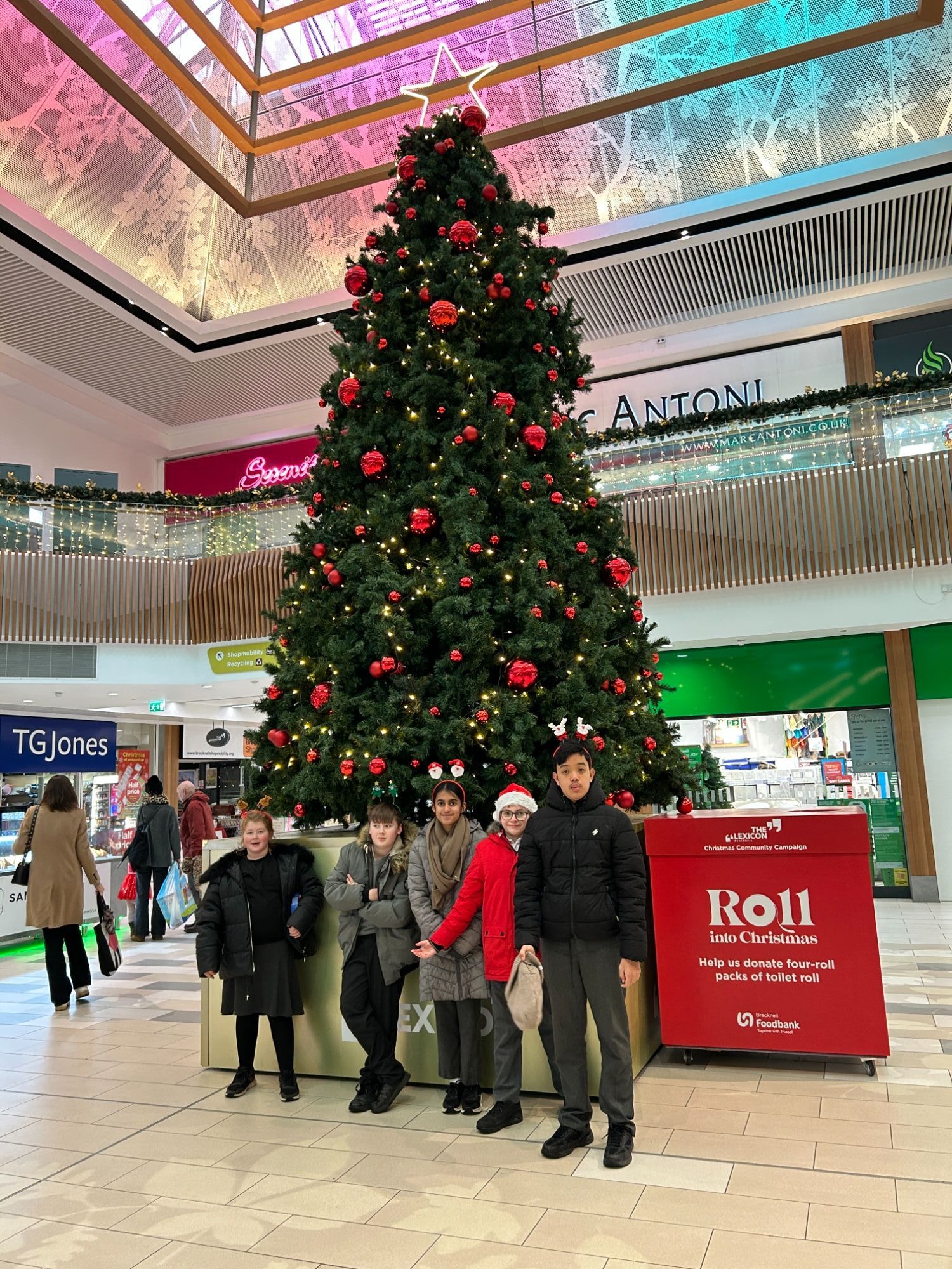 Earth class by a Christmas tree in the shopping centre