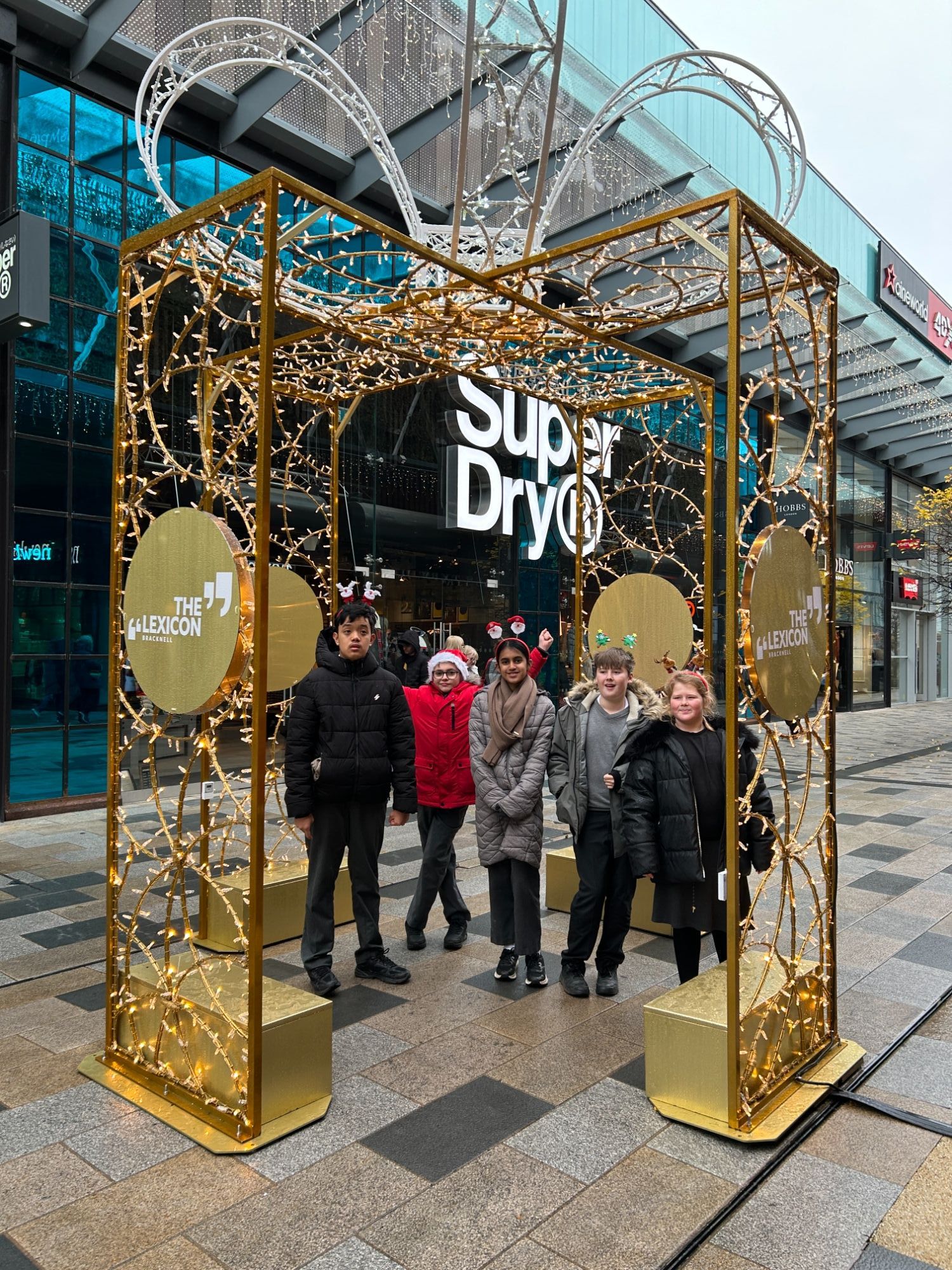 Earth class by a big Christmas present decoration outside