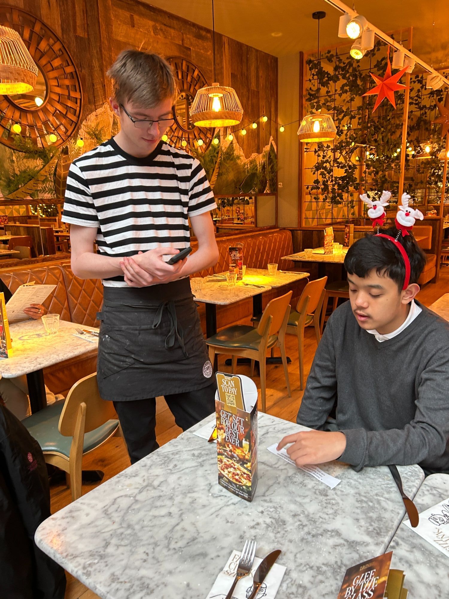 Another boy ordering his meal from the waiter